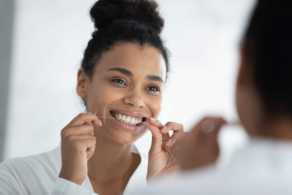 woman flossing her teeth