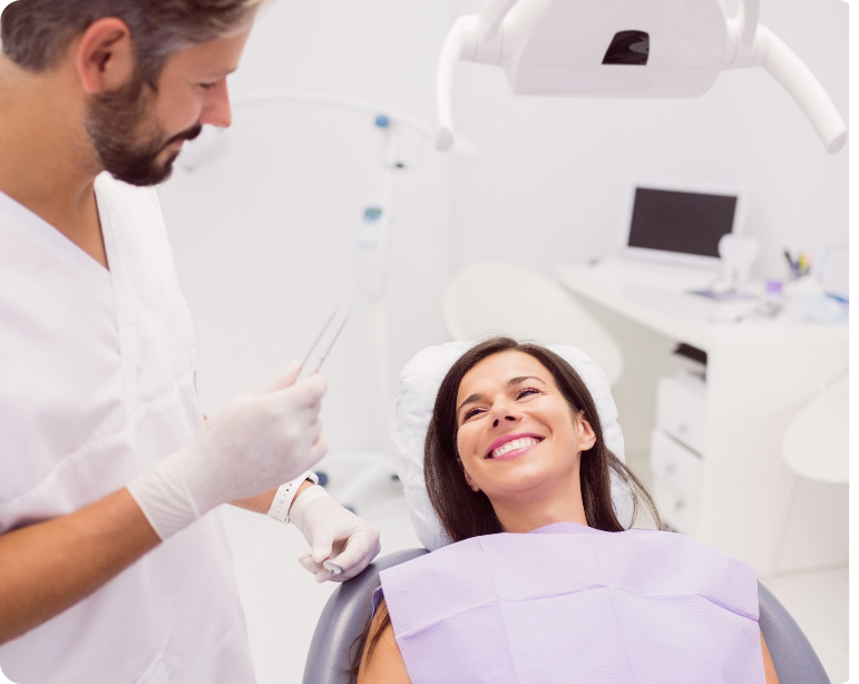 Dentist With Smiling Female Patient